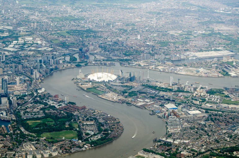 Aerial view of the River Thames at North Greenwich, London. The millennium dome is in the centre of the image with the new arts development of City Island on the opposite side of the river. The Excel Centre to the right hand side with the Royal Docks. At the bottom left is Mudchute.